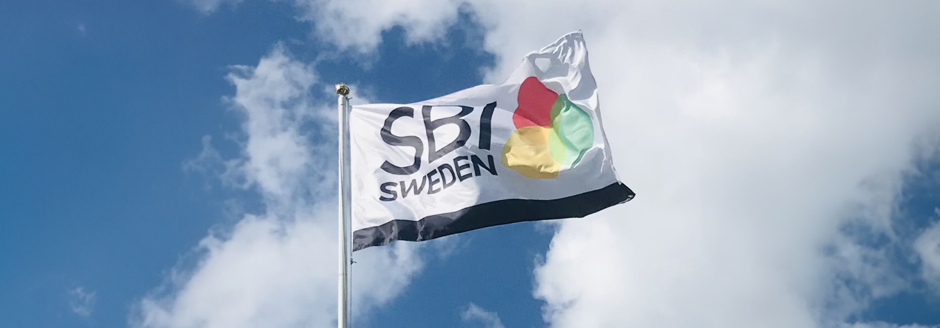 SBI Sweden flag waving against a clear blue sky, symbolizing national pride and identity.