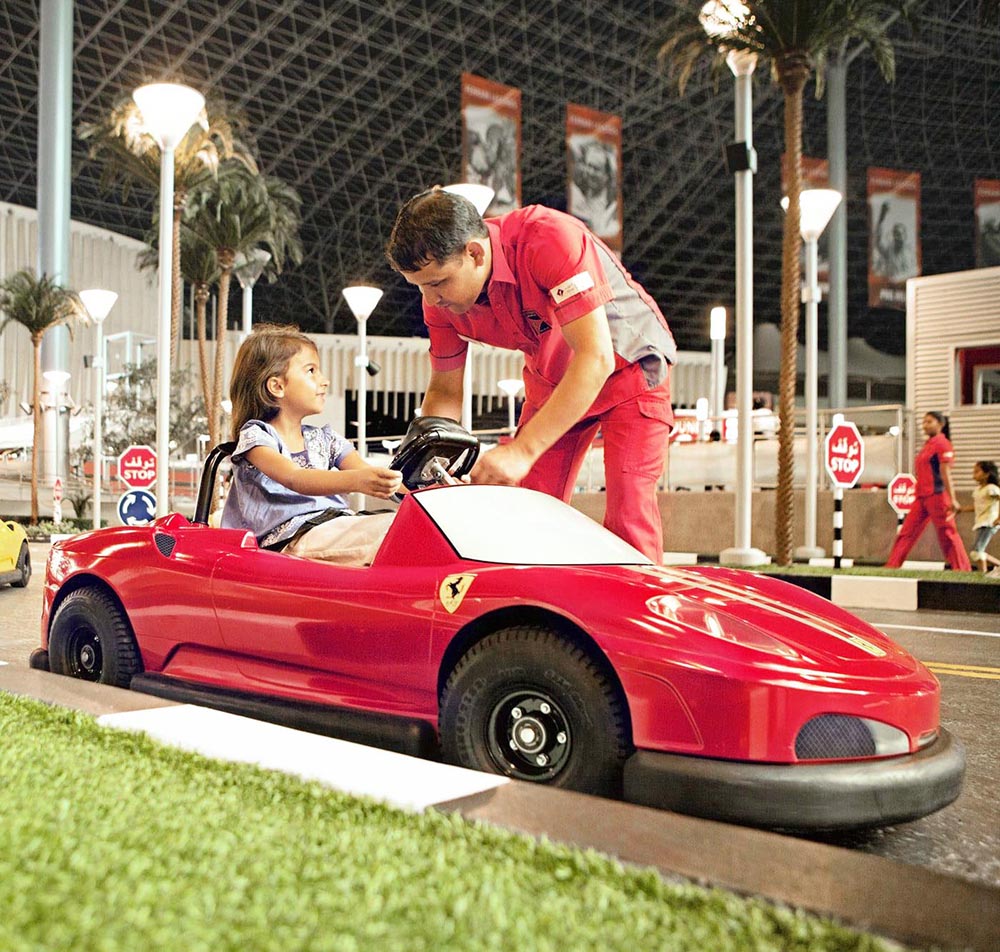 Girl drive Ferrari World Abu Dhabi Rides for Amusement parks Organization and the Company