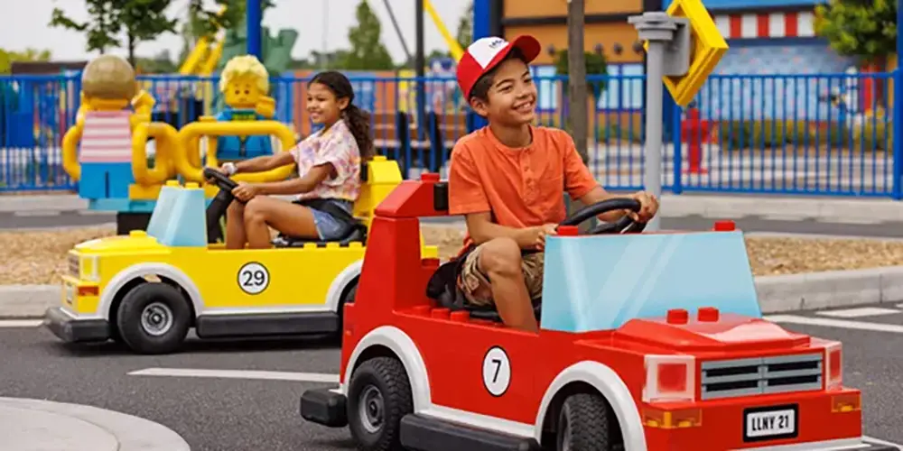 Happy children driving cars at Legoland's Driving School in New York. The cars are manufactured by SBI Sweden in Jönköping