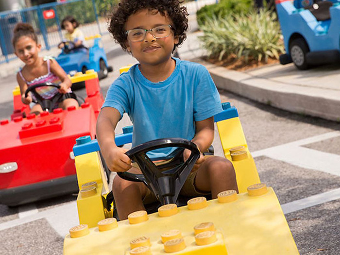 Satisfied boy driving a LEGOland car manufactured by SBI Sweden, enjoying an exciting and interactive play experience