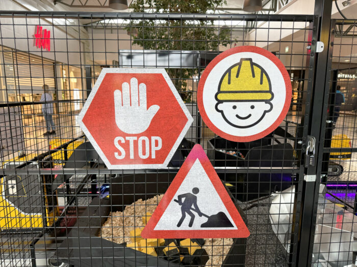 3 different signs on the SBI cage