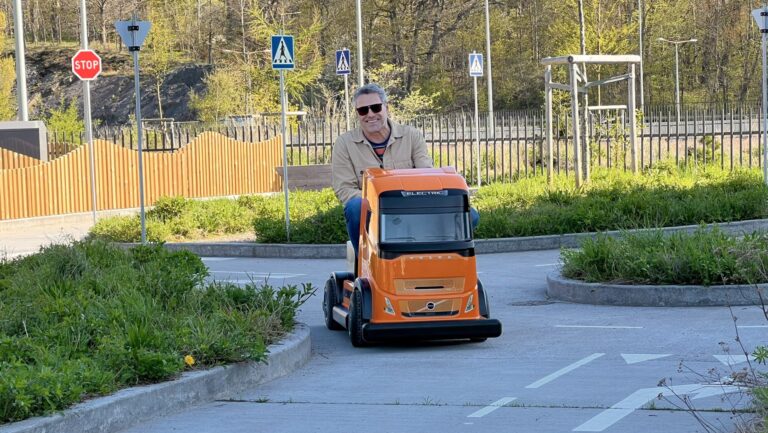 a man riding a miniature volvo FH Aero truck