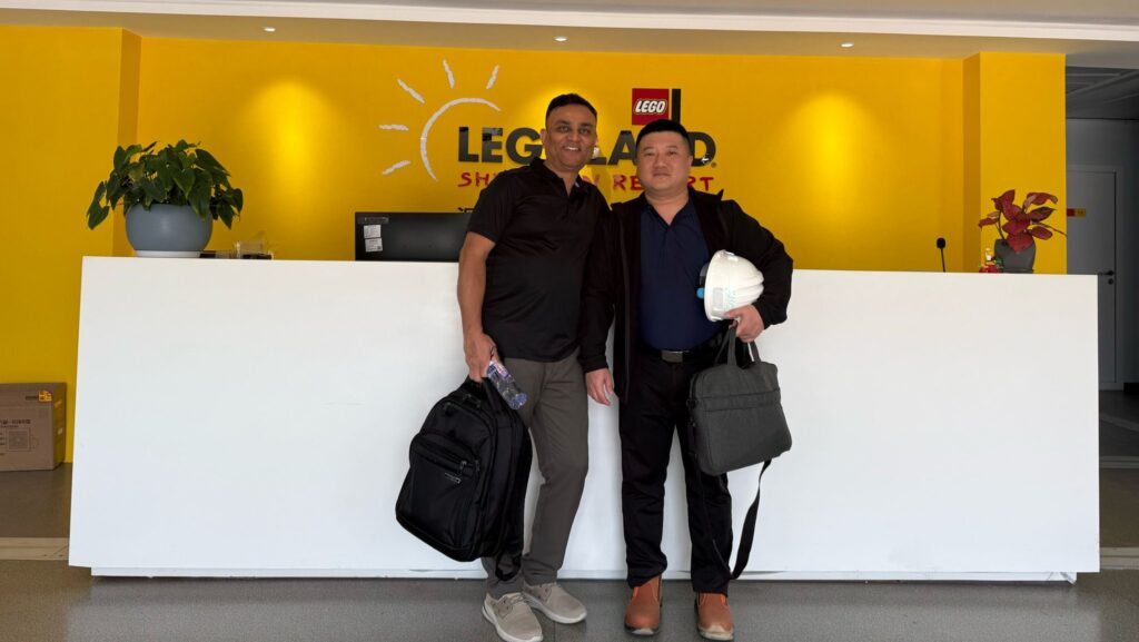 two men infront of a yellow wall